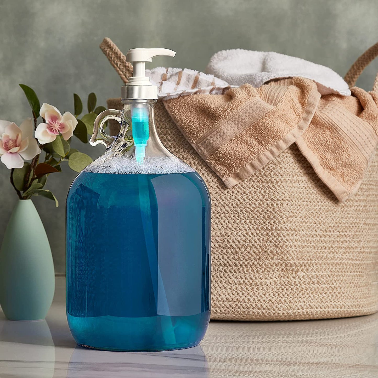 Gallon glass pump bottle holds full detergent jug