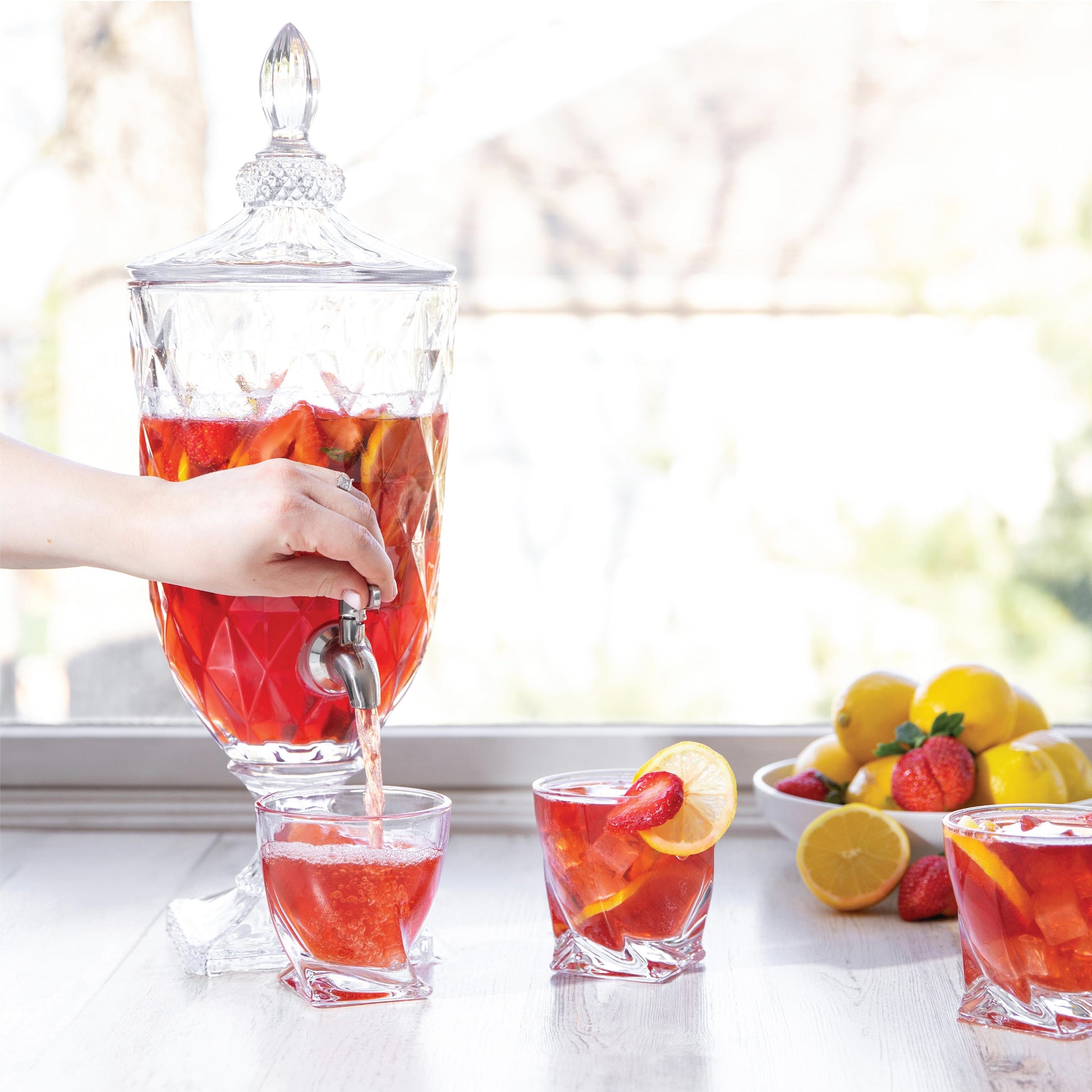 Decorative pedestal drink dispenser, elevated glass base