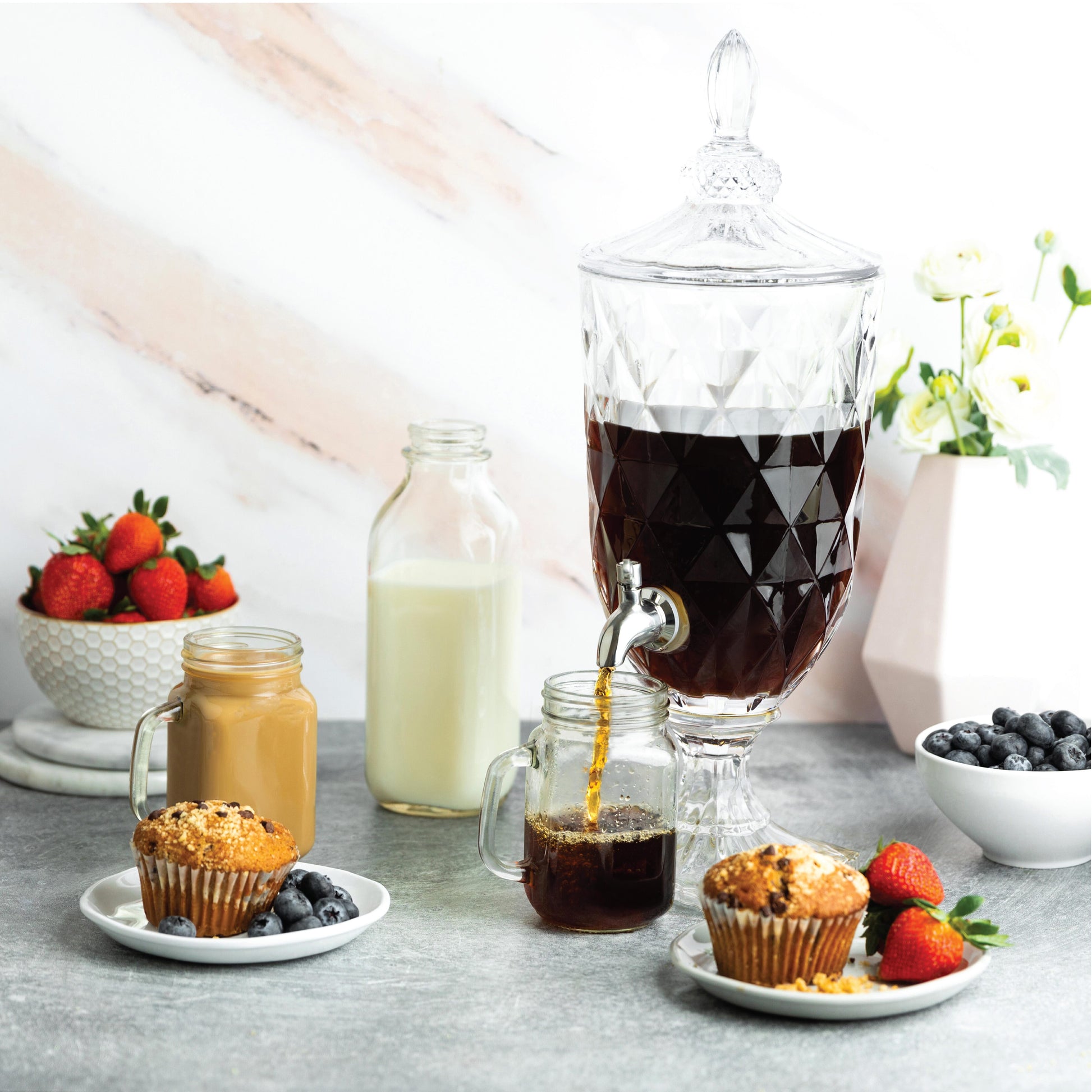 Glass pedestal dispenser filled for serving